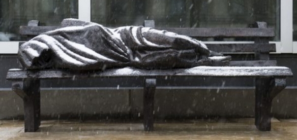 Sculpture-of-Homeless-Jesus-Sleeping-on-Bench-is-Rejected-by-Churches